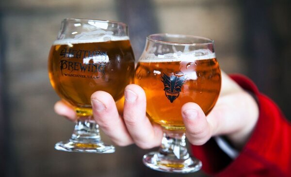 Hand holding two glasses of beer